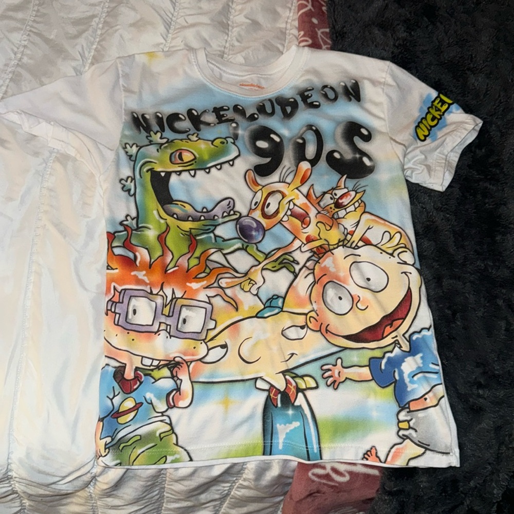 This is a Nickerson 90s shirt size 14-16 girls or boys it’s like neon shirt!